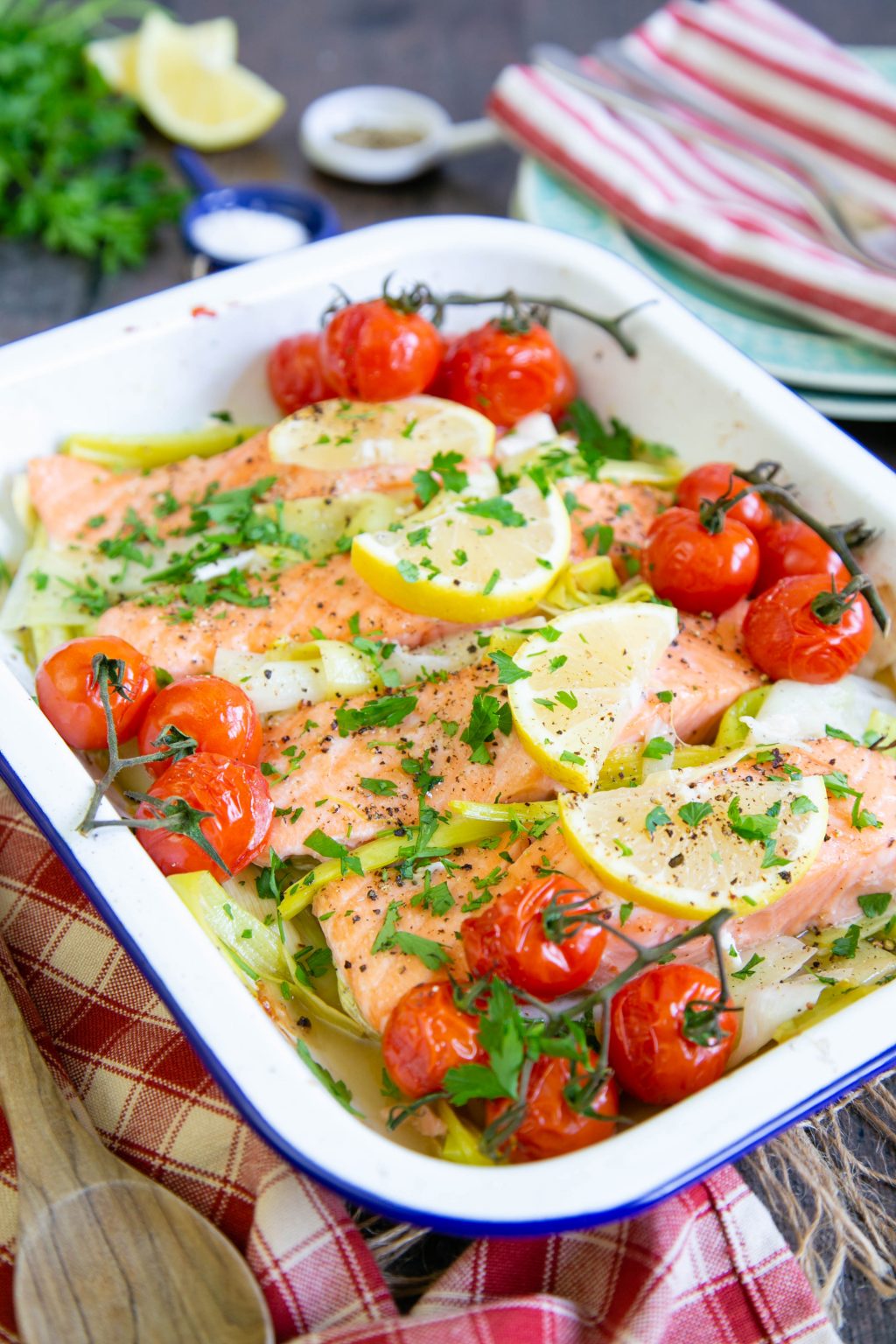 Baked salmon on a bed of leeks with roasted tomatoes British Leeks
