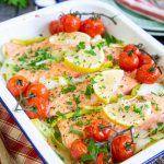 Baked salmon on a bed of leeks with roasted tomatoes